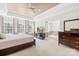 Inviting primary bedroom with multiple windows, a sitting area, and neutral carpeting at 705 Brown Creek Dr, Matthews, NC 28104