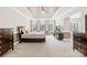 Spacious primary bedroom featuring a tray ceiling, large windows, and an adjacent sitting area at 705 Brown Creek Dr, Matthews, NC 28104