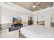 Bright primary bedroom with a tray ceiling, wall paneling, and a television on a glass stand at 705 Brown Creek Dr, Matthews, NC 28104