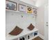 Charming mudroom with built-in bench, storage cubbies, hooks, and playful decor at 705 Brown Creek Dr, Matthews, NC 28104