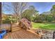 Charming deck with stairs leading to a beautifully landscaped backyard and garden at 7117 Chadwyck Farms Dr, Charlotte, NC 28226