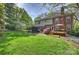 Expansive backyard featuring a well-maintained lawn, deck, and mature trees for privacy at 7117 Chadwyck Farms Dr, Charlotte, NC 28226