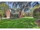 Large backyard with lush greenery, mature trees, and a well-maintained lawn at 7117 Chadwyck Farms Dr, Charlotte, NC 28226