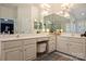 Bright bathroom featuring a glass shower, double vanities, large mirrors, and neutral tile floors at 7117 Chadwyck Farms Dr, Charlotte, NC 28226