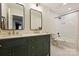 Stylish bathroom with dual sinks, elegant gold fixtures, and a shower-tub combination at 7117 Chadwyck Farms Dr, Charlotte, NC 28226