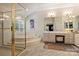 Bright bathroom featuring a glass shower, large tub, vanity with storage, and neutral tile floors at 7117 Chadwyck Farms Dr, Charlotte, NC 28226