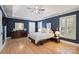 This main bedroom features hardwood floors, trey ceilings, and natural light from the windows at 7117 Chadwyck Farms Dr, Charlotte, NC 28226