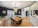 Dining area with stylish chandelier, hardwood floors, and an open view to the foyer at 7117 Chadwyck Farms Dr, Charlotte, NC 28226