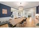 Open concept dining room with custom light fixture and view into the home's foyer at 7117 Chadwyck Farms Dr, Charlotte, NC 28226