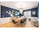 Dining room with dark walls, bench seating, and elegant light fixture at 7117 Chadwyck Farms Dr, Charlotte, NC 28226