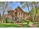 Traditional two-story brick home with lush landscaping, manicured lawn, and inviting curb appeal at 7117 Chadwyck Farms Dr, Charlotte, NC 28226