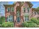Brick facade home featuring an arched entrance, manicured landscaping, and a welcoming staircase at 7117 Chadwyck Farms Dr, Charlotte, NC 28226