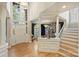 Bright foyer features hardwood floors, a grand chandelier, and a staircase leading to the upper level at 7117 Chadwyck Farms Dr, Charlotte, NC 28226