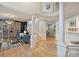 Spacious foyer with hardwood floors, elegant columns, library, and staircase to the second floor at 7117 Chadwyck Farms Dr, Charlotte, NC 28226