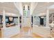 Grand foyer with high ceilings, white columns, and views to the dining room and library at 7117 Chadwyck Farms Dr, Charlotte, NC 28226
