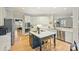 Modern kitchen with center island, stainless steel appliances, white cabinets, and breakfast nook at 7117 Chadwyck Farms Dr, Charlotte, NC 28226