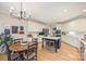 Eat-in kitchen features white cabinets, stainless appliances, kitchen island with cooktop, and hardwood floors at 7117 Chadwyck Farms Dr, Charlotte, NC 28226