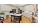 Kitchen with a central island with cooktop, white cabinets, stainless steel appliances, and hardwood floors at 7117 Chadwyck Farms Dr, Charlotte, NC 28226