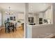 Open-concept kitchen and breakfast nook featuring white cabinets, stainless steel appliances, and hardwood flooring at 7117 Chadwyck Farms Dr, Charlotte, NC 28226