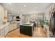 Bright, modern kitchen with center island, stainless steel appliances, and views of the backyard at 7117 Chadwyck Farms Dr, Charlotte, NC 28226