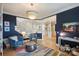 Living room featuring blue walls, hardwood floors, and two blue plush chairs at 7117 Chadwyck Farms Dr, Charlotte, NC 28226