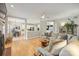 Bright, open living room with hardwood floors, fireplace, and seamless flow to the kitchen and dining area at 7117 Chadwyck Farms Dr, Charlotte, NC 28226
