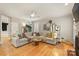 Relaxing living room offering a sectional sofa, hardwood floor, and natural light at 7117 Chadwyck Farms Dr, Charlotte, NC 28226
