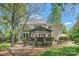 Sprawling backyard featuring deck, patio, lush landscaping and mature trees at 7316 Versailles Ln, Charlotte, NC 28277