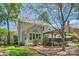 Sprawling backyard featuring deck, patio, lush landscaping and mature trees at 7316 Versailles Ln, Charlotte, NC 28277