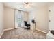 Neutral toned bedroom with carpet, ceiling fan, a white desk and a window to bring in light at 7316 Versailles Ln, Charlotte, NC 28277