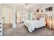 Bright, comfortable bedroom with white walls, plush carpet, a ceiling fan, and an attached bathroom at 7316 Versailles Ln, Charlotte, NC 28277