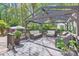 Outdoor deck with covered pergola, wicker furniture, and a view of the landscaped backyard at 7316 Versailles Ln, Charlotte, NC 28277