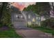 Elegant two-story home with a two-car garage, lush landscaping, and a welcoming driveway at 7316 Versailles Ln, Charlotte, NC 28277