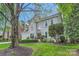 Charming two-story home featuring a beautifully landscaped front yard and classic architectural details at 7316 Versailles Ln, Charlotte, NC 28277