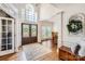 Grand foyer with a soaring window, hardwood floors, and a view to the dining area at 7316 Versailles Ln, Charlotte, NC 28277