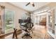 Office with a large window, workstation, hardwood floors, and a ceiling fan at 7316 Versailles Ln, Charlotte, NC 28277