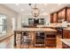Spacious kitchen with a large island, stainless steel appliances, wine cooler, and granite countertops at 7316 Versailles Ln, Charlotte, NC 28277