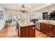 Bright kitchen featuring granite counters, wood floors, stainless steel appliances, and a view to the patio at 7316 Versailles Ln, Charlotte, NC 28277