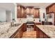 Well-equipped kitchen featuring wood cabinets, granite countertops, and stainless steel appliances at 7316 Versailles Ln, Charlotte, NC 28277
