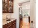 Kitchen area featuring granite counters, stainless steel refrigerator, and wood cabinets at 7316 Versailles Ln, Charlotte, NC 28277