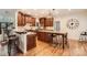 Spacious kitchen with wood cabinets, an island with seating, and hardwood floors at 7316 Versailles Ln, Charlotte, NC 28277