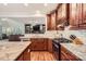 Kitchen featuring stainless appliances, granite countertops, white subway tile backsplash, and wood cabinets at 7316 Versailles Ln, Charlotte, NC 28277
