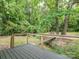 Outdoor deck with wooded views overlooking the stream with cable railing and natural surroundings at 803 E 13Th St, Kannapolis, NC 28083