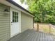 The backyard features a wood deck, green vinyl siding, and a partially wooded area at 803 E 13Th St, Kannapolis, NC 28083