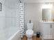 Bright bathroom with a tub and shower combo features a white vanity and modern fixtures with a window for natural light at 803 E 13Th St, Kannapolis, NC 28083