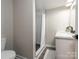 Bathroom with a white vanity, black fixtures, a toilet, and a shower with marble-look tile and black and white patterned floor at 803 E 13Th St, Kannapolis, NC 28083