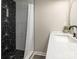 This stylish bathroom features a modern vanity and a shower with unique geometric black and white tiles at 803 E 13Th St, Kannapolis, NC 28083