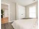 This serene bedroom features neutral colors, wood-look flooring, and ample storage space with a large closet at 803 E 13Th St, Kannapolis, NC 28083