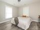 Bright bedroom featuring hardwood floors, a comfortable bed, and plenty of natural light at 803 E 13Th St, Kannapolis, NC 28083