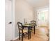 Cozy dining area with a black table and chairs, wood flooring, and a view of the backyard through a doorway at 803 E 13Th St, Kannapolis, NC 28083